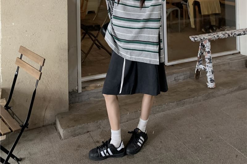 Striped Long-Sleeve Polo Paired with Cinched A-Line Skirt